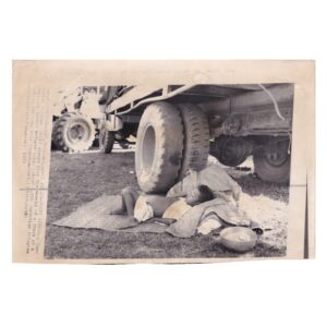 Associated Press Wire Photograph - Cambodian Refugee Child Sheltering Beneath Relief Truck -April 1975