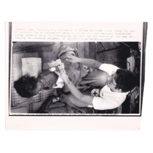 Associated Press Wire Photograph - Red Cross Doctor Treating Severely Malnourished Cambodian Child, Thai Refugee Camp - 1979