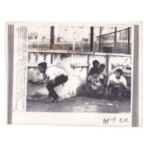 Associated Press Wire Photograph - Cambodian Civilians Taking Cover During Phnom Penh Shootout - February 1971